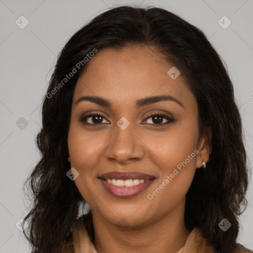 Joyful black young-adult female with long  brown hair and brown eyes