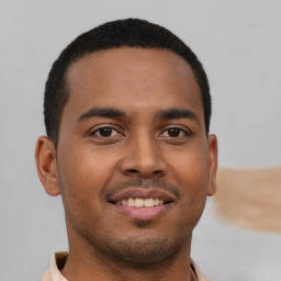 Joyful latino young-adult male with short  brown hair and brown eyes