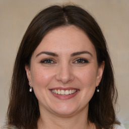 Joyful white young-adult female with medium  brown hair and brown eyes