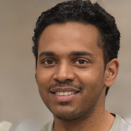 Joyful black young-adult male with short  black hair and brown eyes