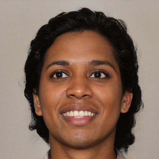 Joyful black young-adult female with medium  black hair and brown eyes
