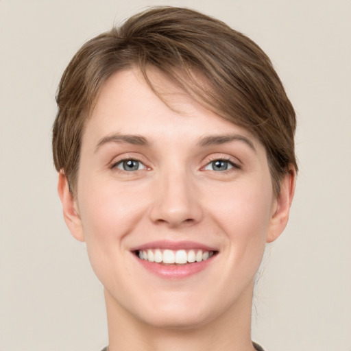 Joyful white young-adult female with short  brown hair and grey eyes