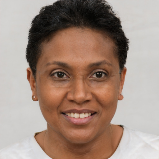 Joyful black adult female with short  brown hair and brown eyes