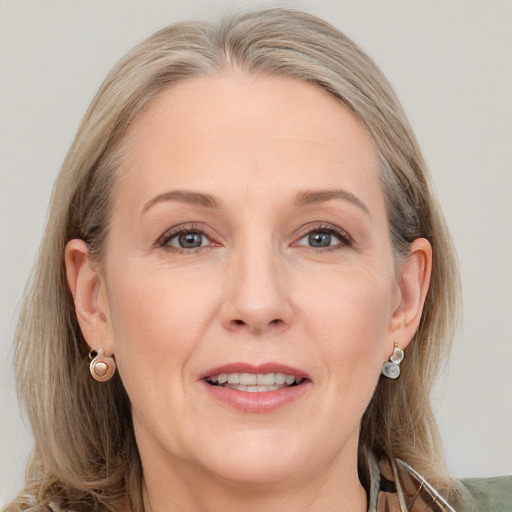 Joyful white adult female with medium  brown hair and grey eyes