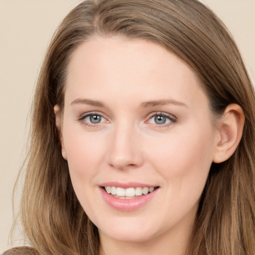 Joyful white young-adult female with long  brown hair and grey eyes