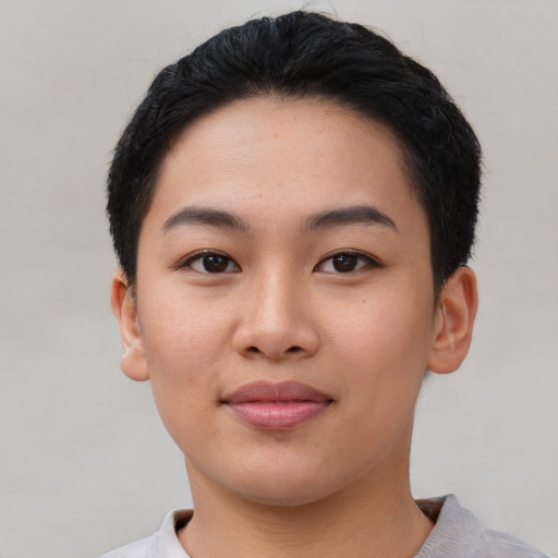 Joyful asian young-adult female with short  black hair and brown eyes