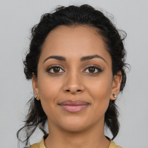 Joyful latino young-adult female with medium  brown hair and brown eyes