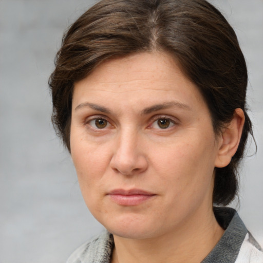 Joyful white adult female with medium  brown hair and grey eyes