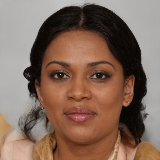 Joyful black adult female with medium  brown hair and brown eyes