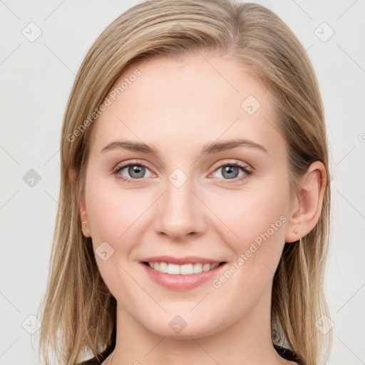 Joyful white young-adult female with long  brown hair and blue eyes