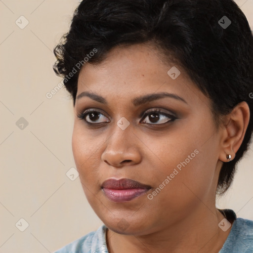 Joyful black young-adult female with medium  brown hair and brown eyes