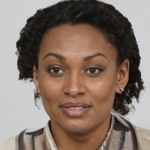 Joyful black adult female with short  brown hair and brown eyes