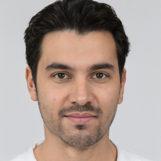 Joyful white young-adult male with short  black hair and brown eyes