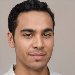 Joyful latino young-adult male with short  brown hair and brown eyes