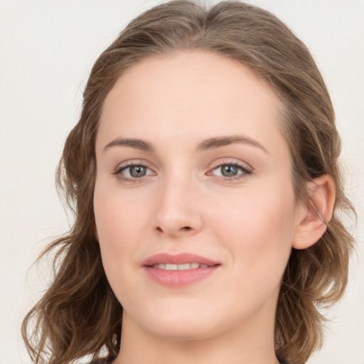 Joyful white young-adult female with long  brown hair and blue eyes