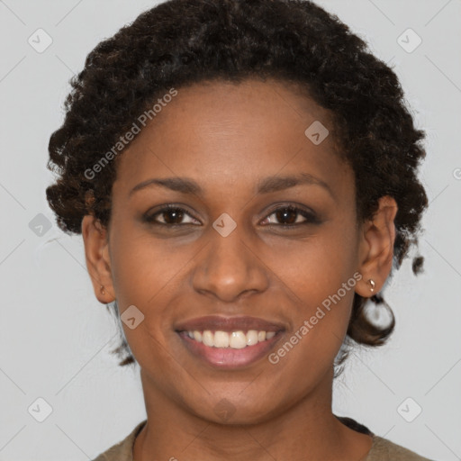 Joyful black young-adult female with short  brown hair and brown eyes