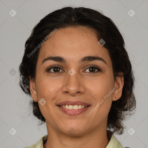 Joyful latino adult female with medium  brown hair and brown eyes