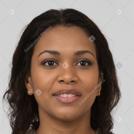 Joyful black young-adult female with long  brown hair and brown eyes