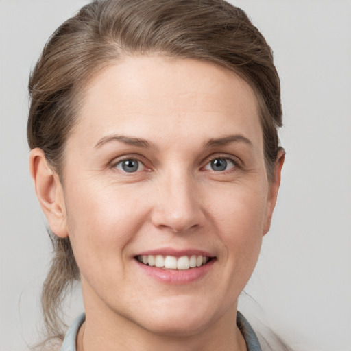 Joyful white young-adult female with short  brown hair and grey eyes