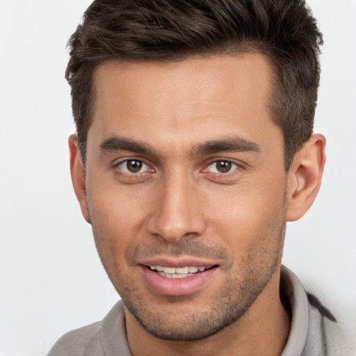 Joyful white young-adult male with short  brown hair and brown eyes