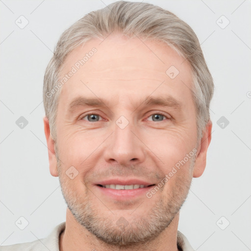 Joyful white adult male with short  brown hair and grey eyes