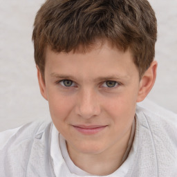 Joyful white child male with short  brown hair and brown eyes