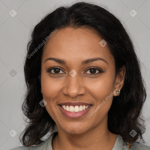 Joyful black young-adult female with long  brown hair and brown eyes