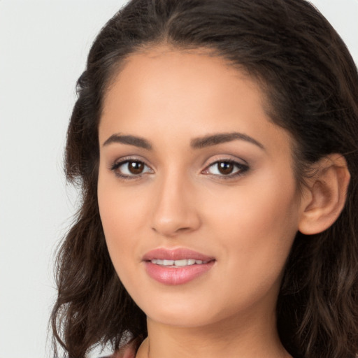 Joyful white young-adult female with long  brown hair and brown eyes