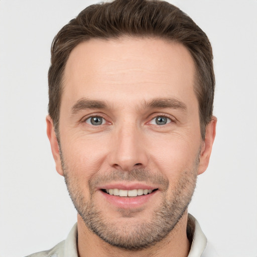 Joyful white young-adult male with short  brown hair and brown eyes