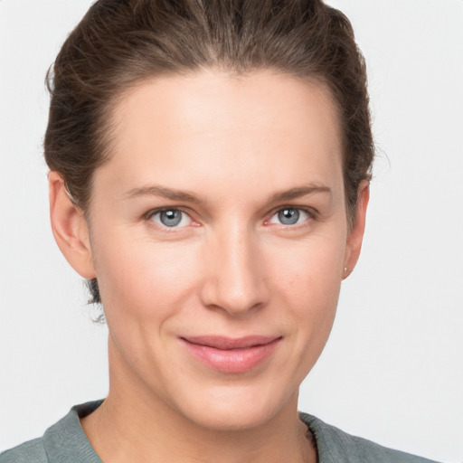 Joyful white young-adult female with short  brown hair and grey eyes