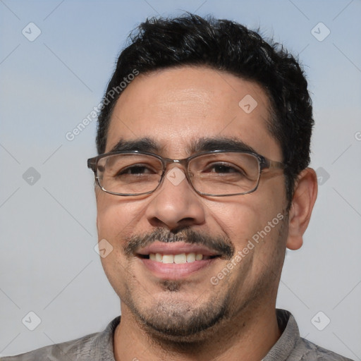 Joyful white adult male with short  black hair and brown eyes