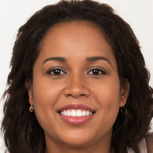 Joyful latino young-adult female with long  brown hair and brown eyes