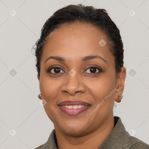 Joyful latino adult female with short  brown hair and brown eyes