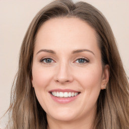 Joyful white young-adult female with long  brown hair and grey eyes