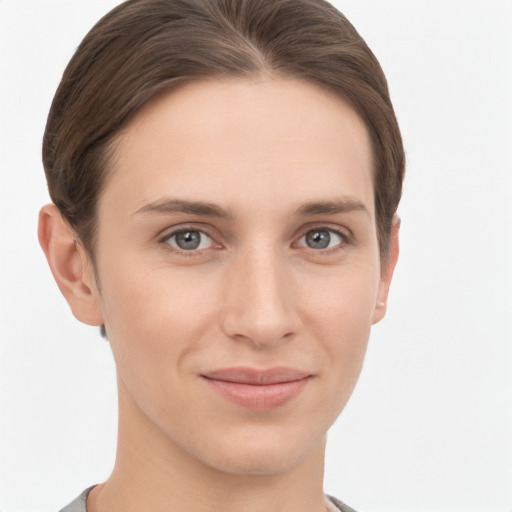 Joyful white young-adult female with short  brown hair and grey eyes