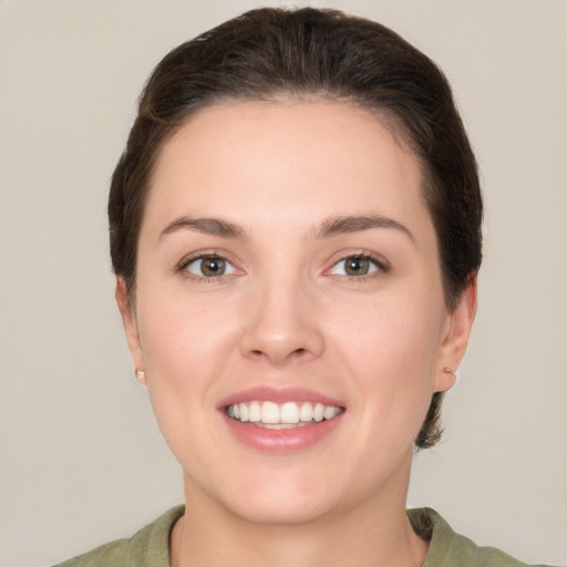 Joyful white young-adult female with medium  brown hair and brown eyes