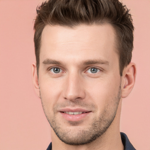 Joyful white young-adult male with short  brown hair and brown eyes