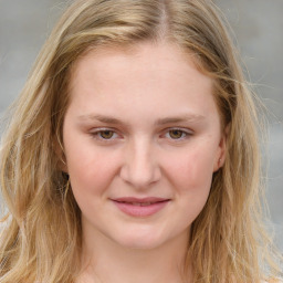 Joyful white young-adult female with long  brown hair and blue eyes