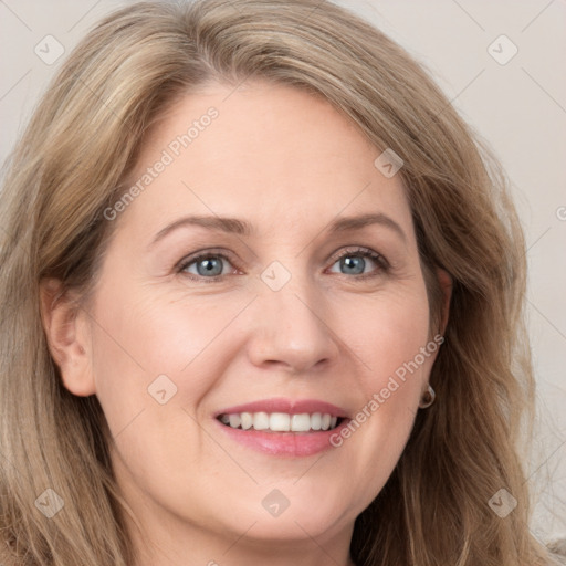 Joyful white adult female with long  brown hair and grey eyes