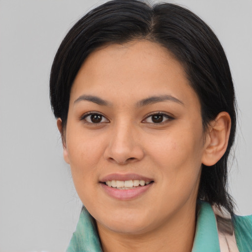 Joyful asian young-adult female with medium  brown hair and brown eyes