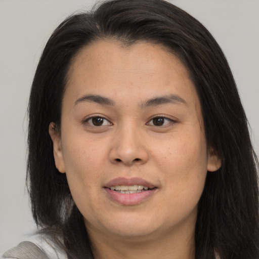 Joyful asian young-adult female with medium  brown hair and brown eyes