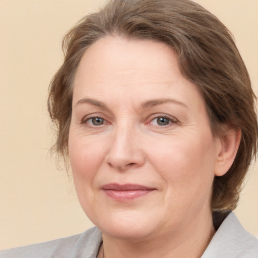 Joyful white adult female with medium  brown hair and brown eyes