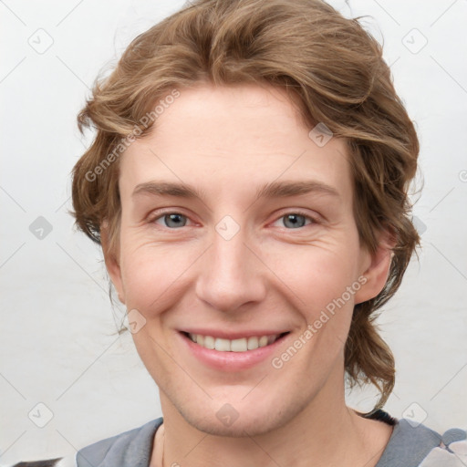 Joyful white young-adult female with short  brown hair and blue eyes