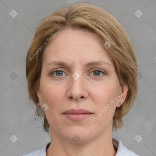 Joyful white adult female with medium  brown hair and blue eyes