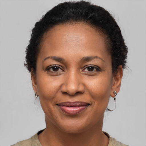 Joyful black adult female with short  brown hair and brown eyes