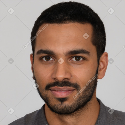 Joyful latino young-adult male with short  black hair and brown eyes