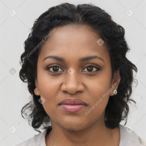 Joyful black young-adult female with long  black hair and brown eyes