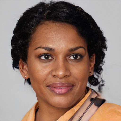 Joyful black adult female with medium  black hair and brown eyes
