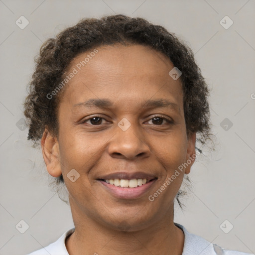 Joyful black adult female with short  brown hair and brown eyes