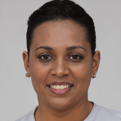 Joyful latino young-adult female with short  black hair and brown eyes